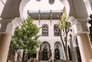 a building with trees in front of it at Riad Maison Bleue and Spa in Fez