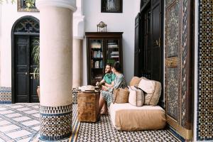 two people sitting in a room with a pillar at Riad Maison Bleue and Spa in Fez