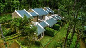 an aerial view of a house with blue roofs at Sitaram Mountain Retreat in Munnar