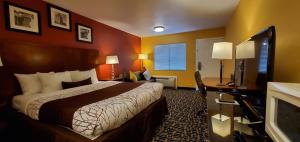 a hotel room with a bed and a desk at Apple Inn Motel in Chelan