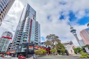a tall building with the cn tower in the background at Amazing Harbour, Skytower and Rangitoto Views in Auckland