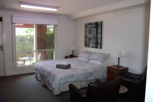a bedroom with a large bed and a window at Box Hill Studio 3 at Canterbury Gardens in Box Hill