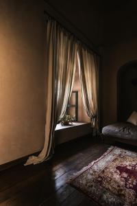 a bedroom with a bed and a window with a rug at Imaret in Kavála