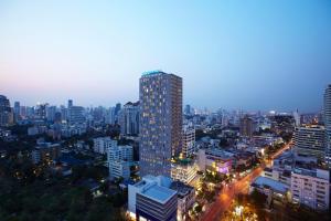 a city skyline at night with a tall building at Somerset Sukhumvit Thonglor Bangkok in Bangkok +55 photos