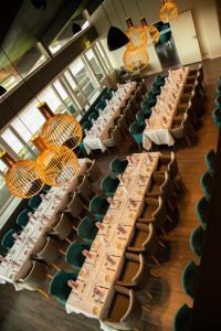uma sala de jantar com mesas longas com pratos de comida em Hotell Jæren em Bryne