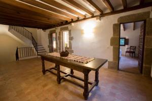 a room with a table in the middle of a room at Alquiler de casa rural completa: Masía del siglo XV en la Costa Brava in Santa Cristina d'Aro