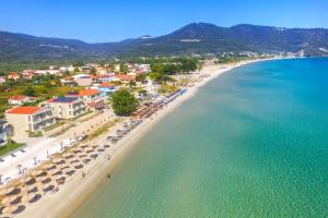an aerial view of a beach with umbrellas and the ocean at Iliorama Luxury Apartments in Skala Potamias
