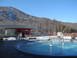 a swimming pool in the snow next to a building at Apartments & Ferienhaus Senftner in Thale
