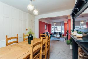 a dining room with a wooden table and chairs at Beautifully Finished Spacious House! in Rugby