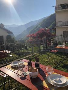 a table with a bowl of food and a bottle of wine at Le Castagne Matte in Stenico