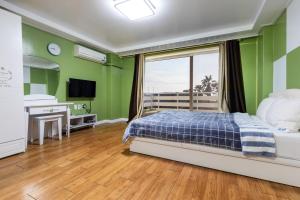 Ένα ή περισσότερα κρεβάτια σε δωμάτιο στο jeju Tovice Condo Ocean +59 φωτογραφίες