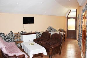 a living room with a couch and chairs and a tv at Apartmany St. Maria in Staré Hory