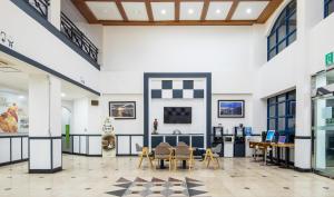 a lobby with tables and chairs in a building at jeju Tovice Condo Ocean in Jeju