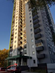 a tall building with a car parked in front of it at Теремки in Kyiv