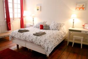 a bedroom with a bed and a desk with two lamps at Key to Bordeaux - fairytale view, 2 bd + elevator in Bordeaux