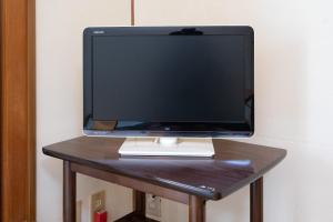 a computer monitor sitting on top of a table at Tabist Hana Hotel Takinoya Aizu-Yanaizu in Yanaizu