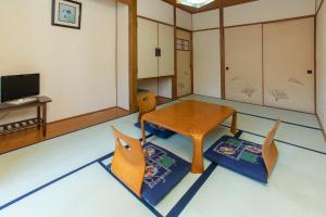 a room with a table and two chairs at Tabist Hana Hotel Takinoya Aizu-Yanaizu in Yanaizu