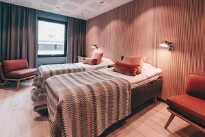 a hotel room with two beds and a chair at Centro Hotel Turku in Turku +54 photos