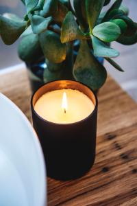 a candle in a vase on a table at Peppertree Terraces in Mudgee