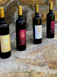 three bottles of wine sitting on a stone wall at Hotel-Clinic Dr. Gechevi in Pavel Banya