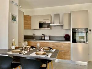 a kitchen with a table with plates on it at Appartamento 23 - bilocale vista lago in Toscolano Maderno