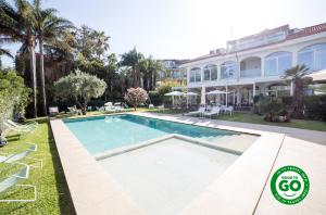 an image of a swimming pool in front of a house at Sicilia's Art Hotel & Spa in Acitrezza