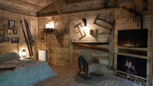 a bedroom with a bed and a tv and a fireplace at Chambres d'hôtes et table d'hôtes L'Intemporelle in Saint Laurent Nouan