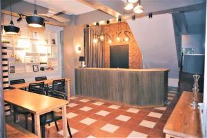 a restaurant with a counter and a table and chairs at Bunks Hostel in Cebu City