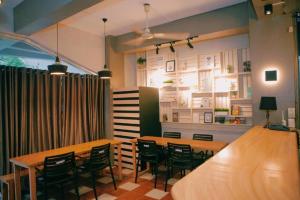 a restaurant with tables and chairs and a bar at Bunks Hostel in Cebu City