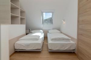 Ένα ή περισσότερα κρεβάτια σε δωμάτιο στο Vila Vita Apartments