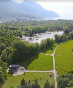 an aerial view of a river with a house and a road at Swiss Lake Lodge in Noville