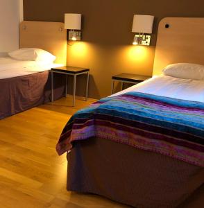 a hotel room with a bed and two night stands at Hotell Charlottenberg in Charlottenberg