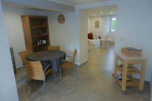 a living room with a black table and chairs at Chez Marcel in Fauvillers