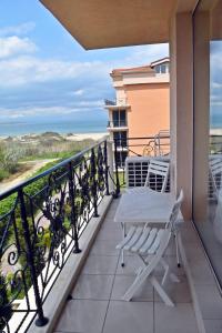 a balcony with a table and a view of the ocean at Anvers Apartments in Sozopol