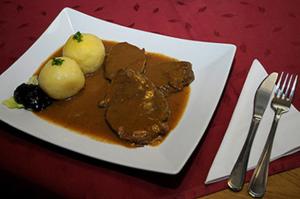 a plate of food on a red table at Landgasthaus Zum Mönchshof in Wolframs-Eschenbach