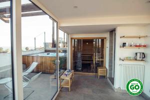 a balcony of a house with a view of a kitchen at Sicilia's Art Hotel & Spa in Acitrezza