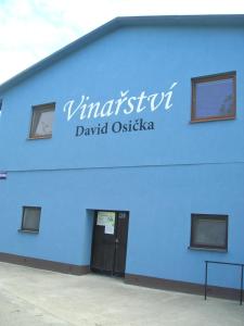 un edificio azul con un cartel en el costado en VINAŘSTVÍ DAVID OSIČKA, en Velké Bílovice