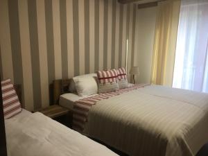 Postel nebo postele na pokoji v ubytování Apartmány POCO LOCO