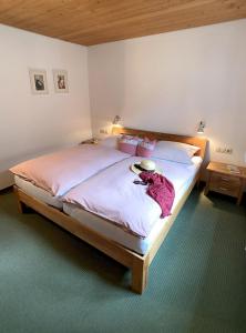 a bedroom with a bed with a teddy bear on it at Haus Claudia Lipp in Bad Hindelang
