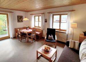 a living room with a table and a dining room at Haus Claudia Lipp in Bad Hindelang