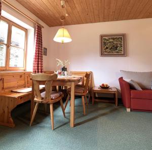 a living room with a table and a couch at Haus Claudia Lipp in Bad Hindelang