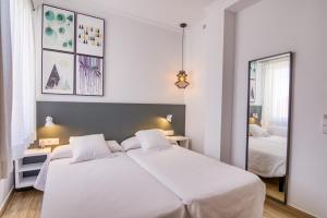 Postel nebo postele na pokoji v ubytování Hostal La Isla