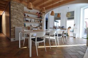 a dining room with a white table and chairs at B&B Sant Pol - Adults Only in San Pol de Mar