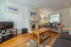 a living room with a couch and a fireplace at Porthia in Hayle