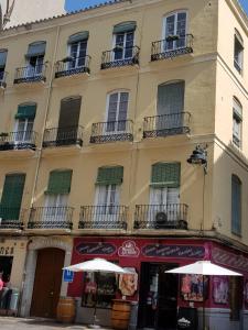 a building with a red umbrella on top of it at Hostal Vidamia in Málaga