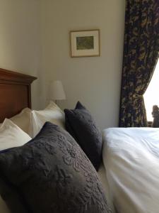 a bed with pillows and pillows on it at Darby's Inn in Stavanger