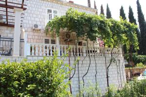 a house with a fence in front of it at Apartment Siesta in Cavtat