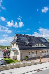 a house with solar panels on the roof at Ferienhaus Seeblick in Binz
