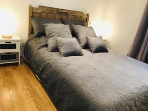 a bed with three pillows on it in a bedroom at Logis de la Clartière in Falleron