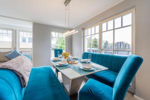 a dining room with blue chairs and a table at Ferienhaus Seeblick in Binz